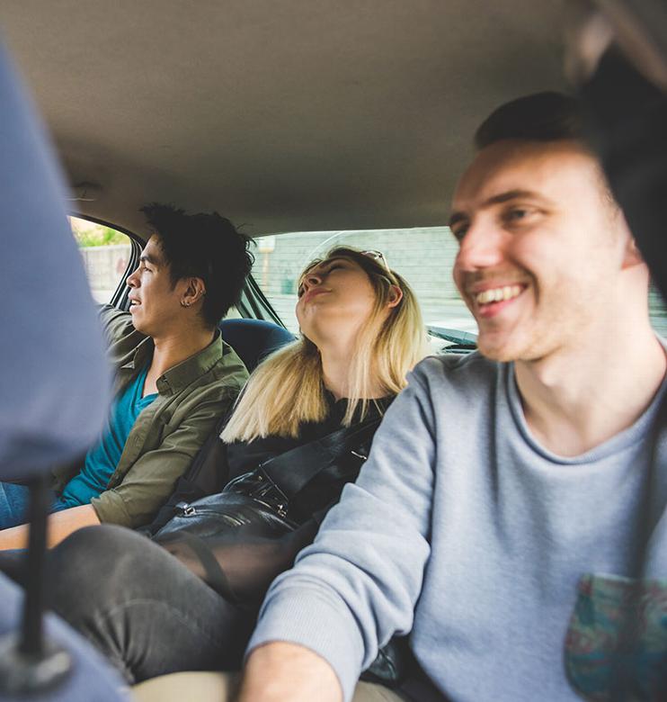 People in the back of a taxi